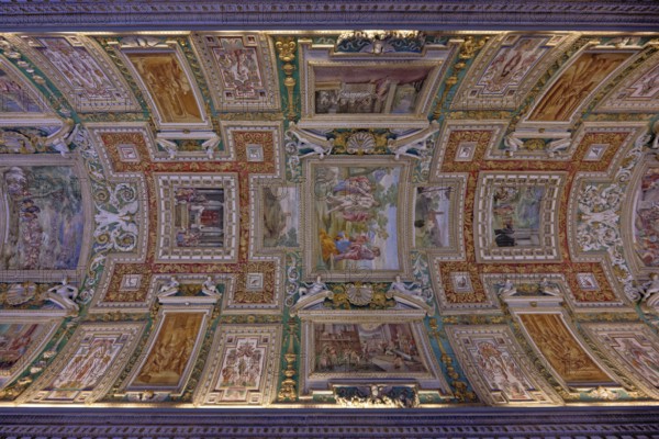 Ornate ceiling featuring detailed frescoes with classical art elements, Galleria delle Carte
