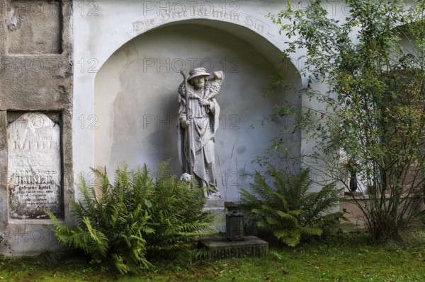 Shepherd carrying a sheep, sculpture in a cemetery, Jakobifriedhof, Leoben, Styria, Austria, Europe