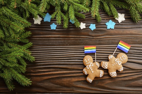 Christmas background of gingerbread man with flag spruce branches and colorful sugar snowflakes on