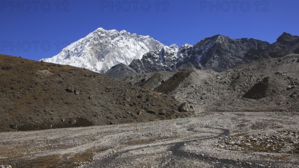 Small creek and azure blue sky over Mount Nuptse, Nepal, Asia