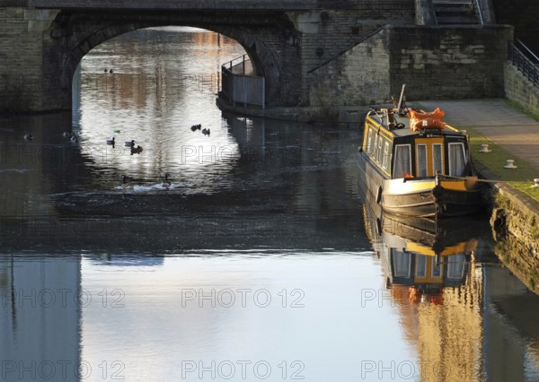 An old traditional narrow boat moored on the canal near brighouse basin in west yorkshire with