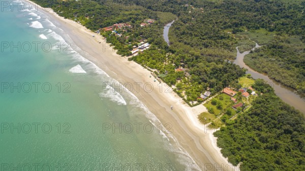 Close-up aerial view of a Green Coast beach with turquoise water, meandering river and forest,
