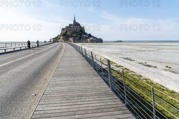 Mont Saint Michel, France, July 25, 2018: View of Mont Saint-Michel against sky. Cyclists on the
