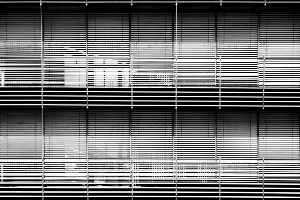 The modern façade of a chemical building and laboratory with highly light-reflecting metal blinds