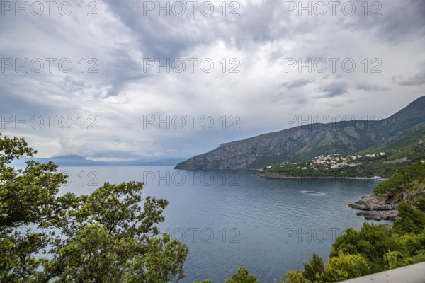 Coastal landscape shot. View from a road leading along the sea and through a breathtaking green