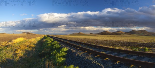 Single railway track at sunset, Central Bohemian Uplands, Czech Republic. Railway track in nature