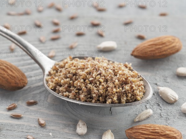 Homemade LSA mix in spoon - Linseed or flax seeds, Sunflower seeds and Almonds. Traditional