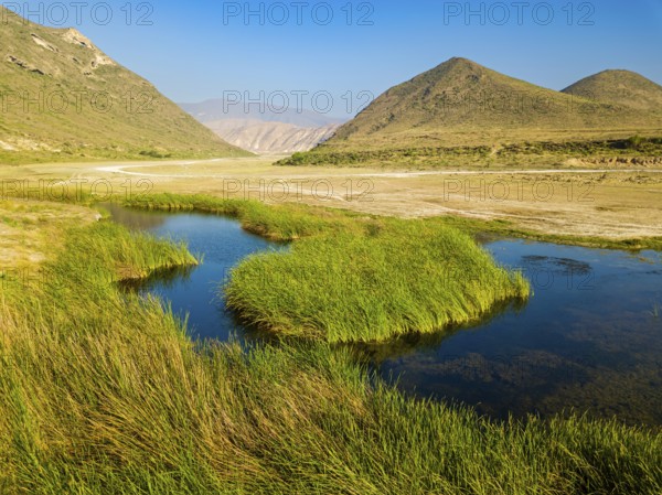 Landscape in Oman, mountains, Wadi Ashawq, road, reeds, waters Salalah, Al Mughsyal / Wadi Ashawq,