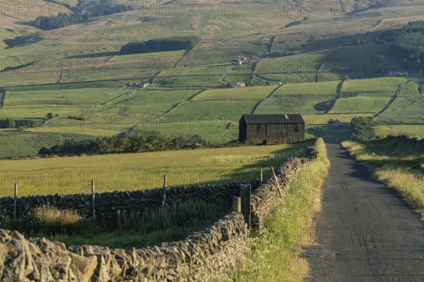 A black barn on the side of a rural road in the Peak District between Rookhope and Ireshopeburn,