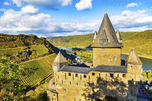 Round towers with conical peaked roofs. Sunset. Rhine Castles: Journey into the German Middle Ages.