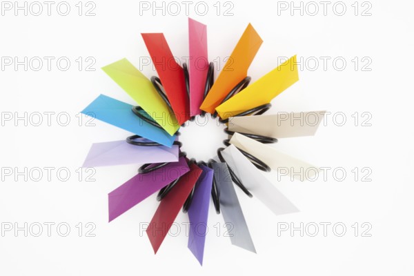 Propeller of colored envelopes on the white table