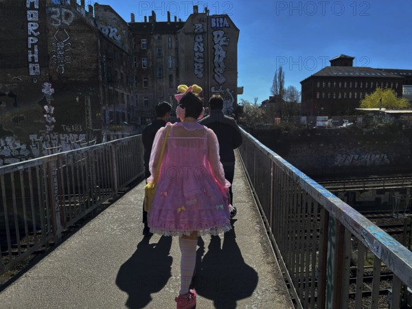 Germany, Berlin, 04.04.2025, girl / woman in pink dress, with bee antennae, Schönfliesser makeshift