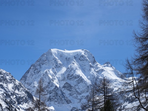 Beautiful view from Arolla, Switzerland, in winter: A high alpine peak with steep slopes covered