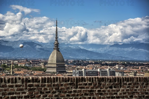 Panoramic view of Turin city center, in Italy, in a sunny day, with Mole Antonelliana and Alps in