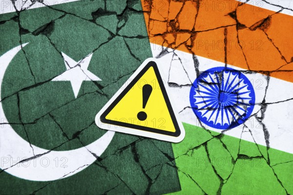 Danger sign with exclamation mark on the flags of Pakistan and India, symbolic photo Kashmir
