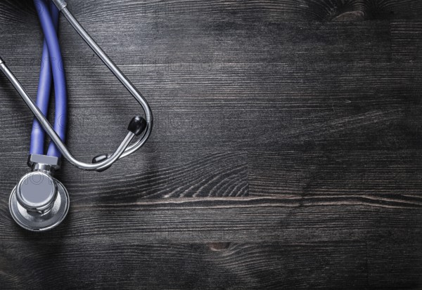 Stethoscope on wooden board copy space medicine concept
