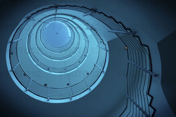 Futuristic spiral staircase in blue light with metallic railings, Free and Hanseatic City of
