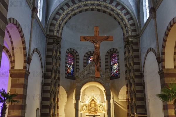 Romanesque church interior with wooden cross, colourful windows and pastoral atmosphere, ankum,