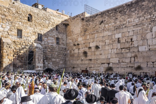 Jerusalem. Jews praying wrapped in festive white Talit. Exciting ceremony at the Western Wall of
