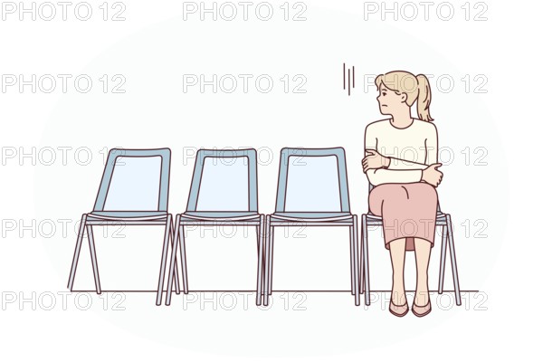 Anxious young woman sit on chair in corridor waiting or appointment. Stressed female feel worried
