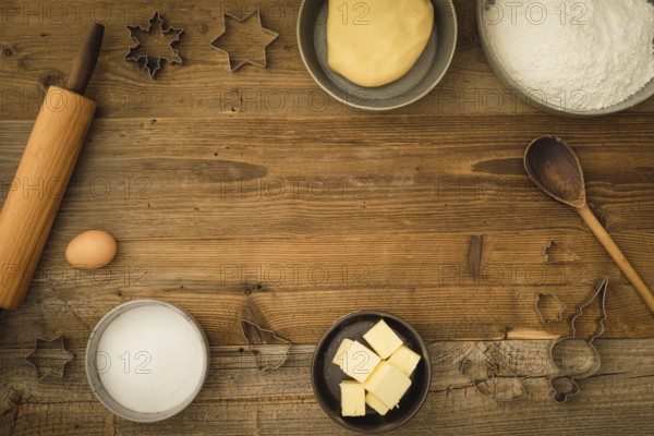 Collection of ingredients and utensils for baking Christmas biscuits with text space in the centre