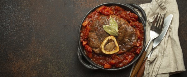 Traditional Italian dish Ossobuco all Milanese made with cut veal shank meat with vegetable tomato
