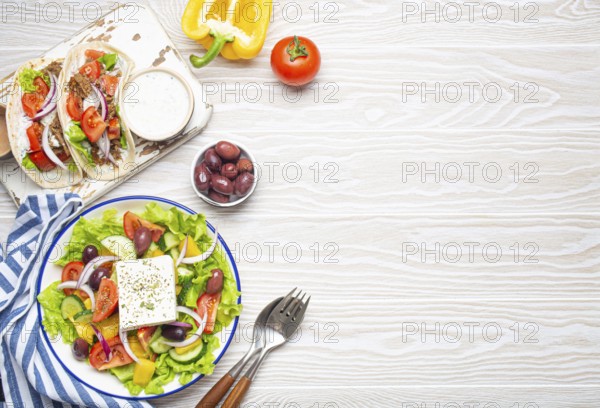 Traditional Greek Food: Greek Salad, Gyros with meat and vegetables, Tzatziki sauce, Olives on