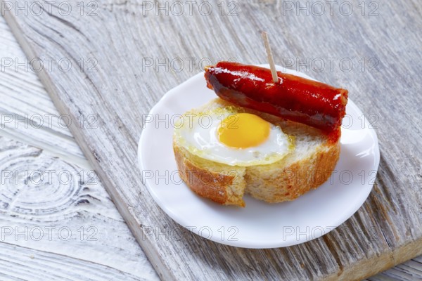 Pinchos pintxos chistorra with quail egg tapas from Spain sausage food