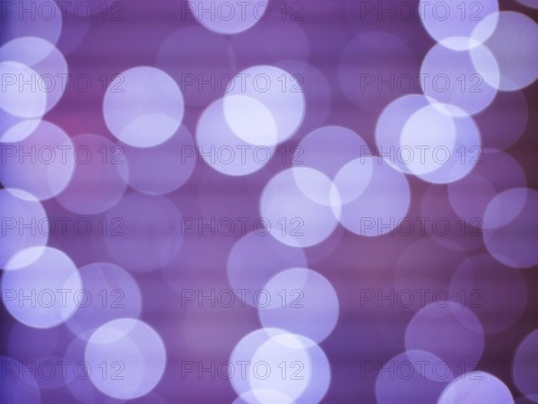 Purple abstract background with bokeh defocused lights. Soft blurred yellow and gold bokeh