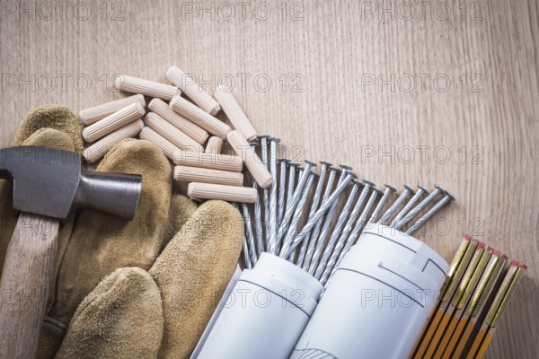 Collection of wooden meter dowels construction drawings claw hammer leather safety gloves and steel