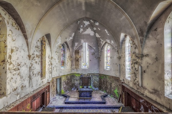 Church interior with colourfully decorated stained glass windows and an old altar, Agnus Dei, Lost
