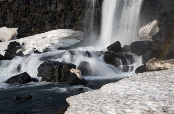 Water from waterfall splashing on a rocky river. The Oxararfoss waterfall in pingvellir Thingvellir