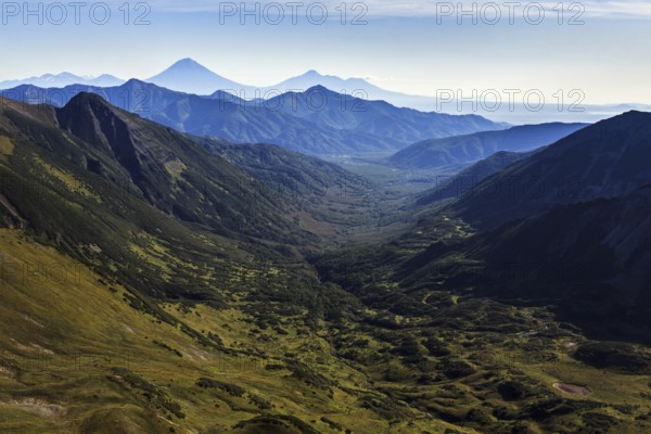 Beautiful autumn mountain landscape: scenery view of mountains, lake and volcanoes. Eurasia,