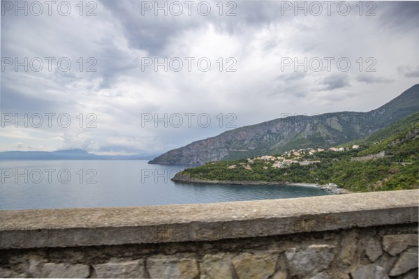 Coastal landscape shot. View from a road leading along the sea and through a breathtaking green