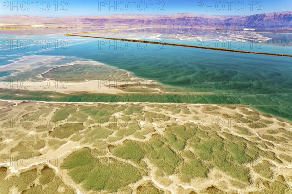 Salt deposits are visible on the seabed. Magic of the Dead Sea. The clear green water of the salty
