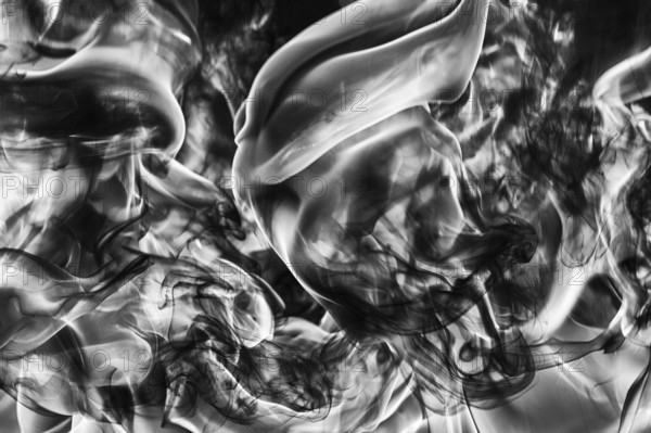 Abstract plume of natural black smoke and white huge flame of strong fire, motion blur from fire,