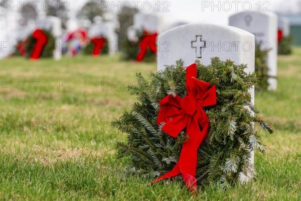 Atop a hill, a veterans cemetery with white headstones and the American flag evokes deep honour,