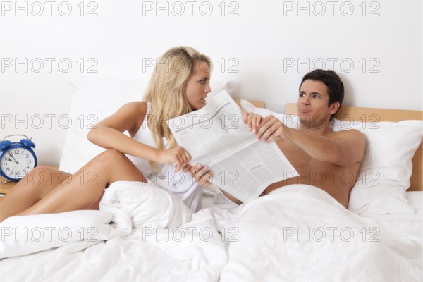 A young couple in bed having problems and crisis. Divorce and separation, A young couple in bed