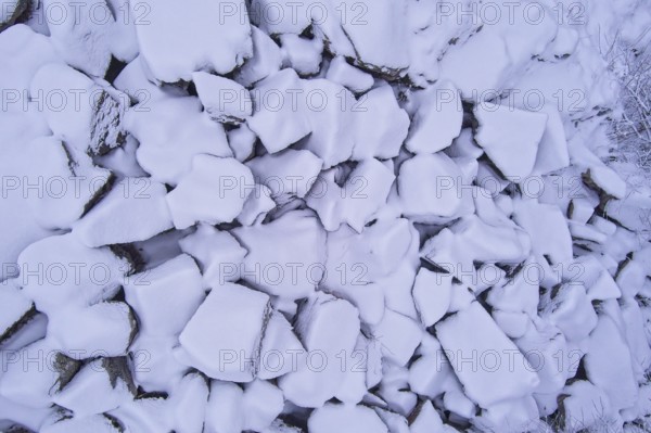 Aerial view of pile of large stones covered with snow in winter, Kuhakoski, Nurmijärvi, Finland,