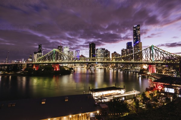 Brisbane skyline and Story Bridge from the suburb of New Farm and Wilson Outlook Reserve at dusk in