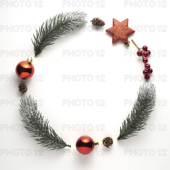 Creative concept still life holiday Christmas photo of fir branches and berries in the shape of