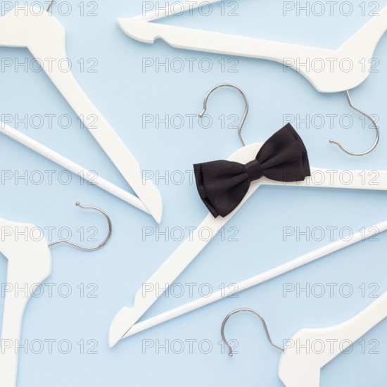 Creative top view flat lay white wooden hangers isolated pastel blue background with copy space