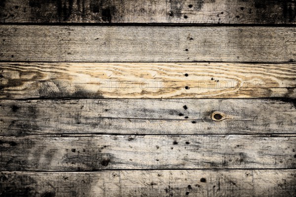 Horizontal wooden planks forming a textured background, weathered and showing knots and grain