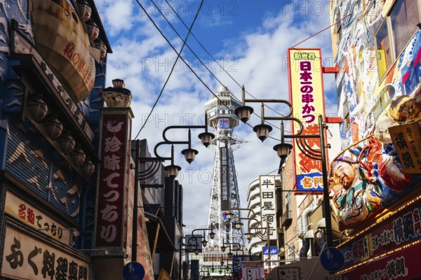 OSAKA, JAPAN - SEPTEMBER 26 2024: The famous Shinsekai area with Tsutenkaku Tower on a clear autumn