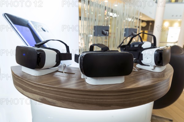 Virtual reality (VR) headsets (glasses) on a table. VR is immersive multimedia or
