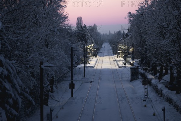 Railway tracks and surroundings covered with snow under winter sun, Allensbach, Lake Constance,