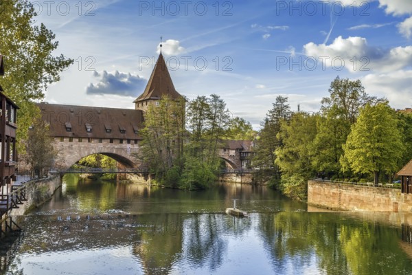 Pedestrian chain bridge (Kettensteg) and the medieval city wall behind it, Nuremberg, Germany,