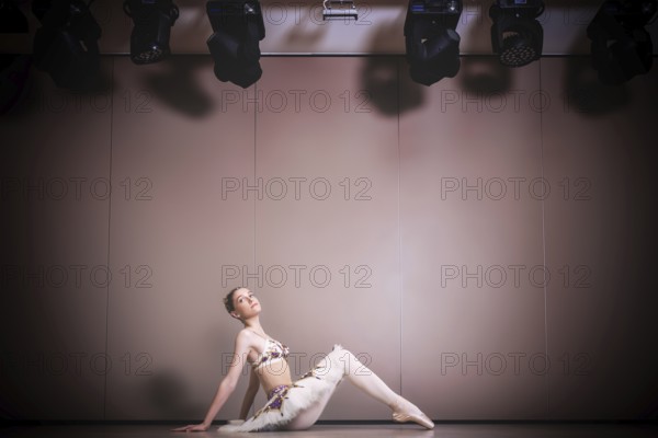 Young beautiful graceful caucasian ballerina practice ballet positions in tutu skirt. Classical