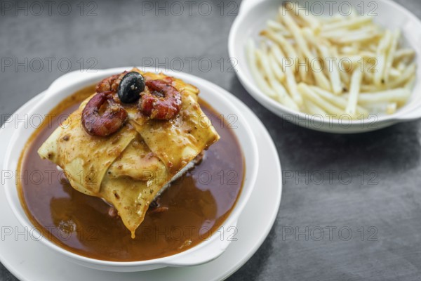 Famous francesinha traditional meat cheese and spicy sauce grilled sandwich of porto portugal