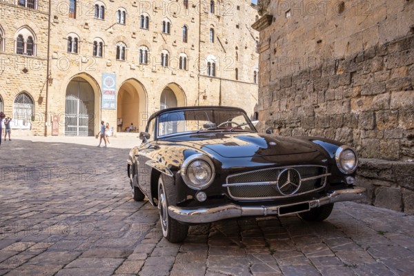 VOLTERRA, ITALY, OCTOBER 15, 2023, A Mercedes Benz 190SL vintage car in the town center of Volterra